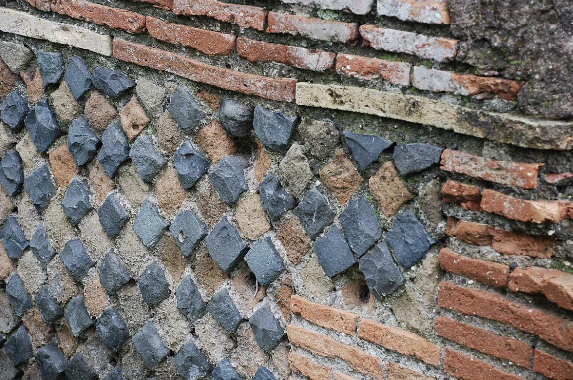 A Wall In Ancient Ostia Where The Bricks Were Laid According To The Scheme Called Opus Reticulatum, With Bricks Arranged Diagonally. The Ancient Romans Knew Earthquake Tremors Were Transmitted Diagonally, And This Could Cope Better Than A Horizontal Pattern