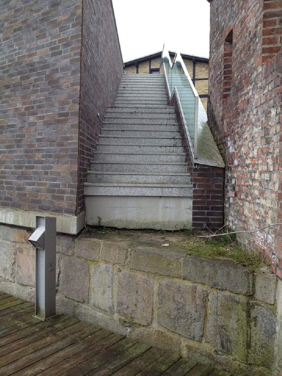 Stone Stairs With Glass Handrail Leading To A Steep Drop
